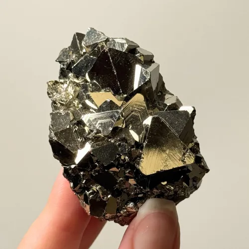 Lab technician comparing Spanish cubic pyrite with Peruvian dendritic specimen under UV light