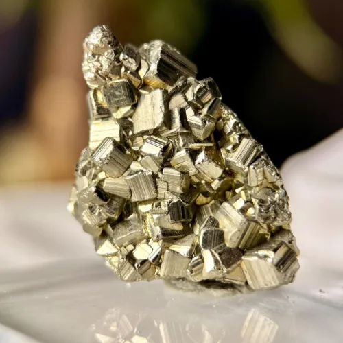 Pyrite cubes next to gold nuggets highlighting visual similarities