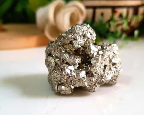 Pyrite jewelry with inlaid crystals on fabric